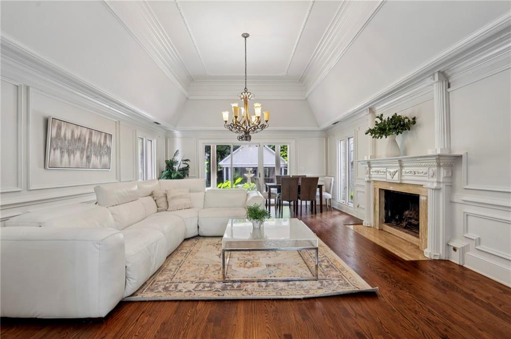 13039 Freemanville Road Alpharetta, GA 30004 - Photo 10 of 62 a living room with furniture a fireplace and a chandelier