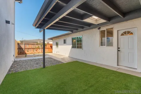 a kitchen with granite countertop white cabinets and stainless steel appliances