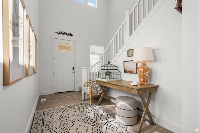 2706 West Maple Street, Unit 285 Mapleton, UT 84664 - Photo 6 of 36 Two-story entryway with wood-finish flooring, white staircase, and transom windows