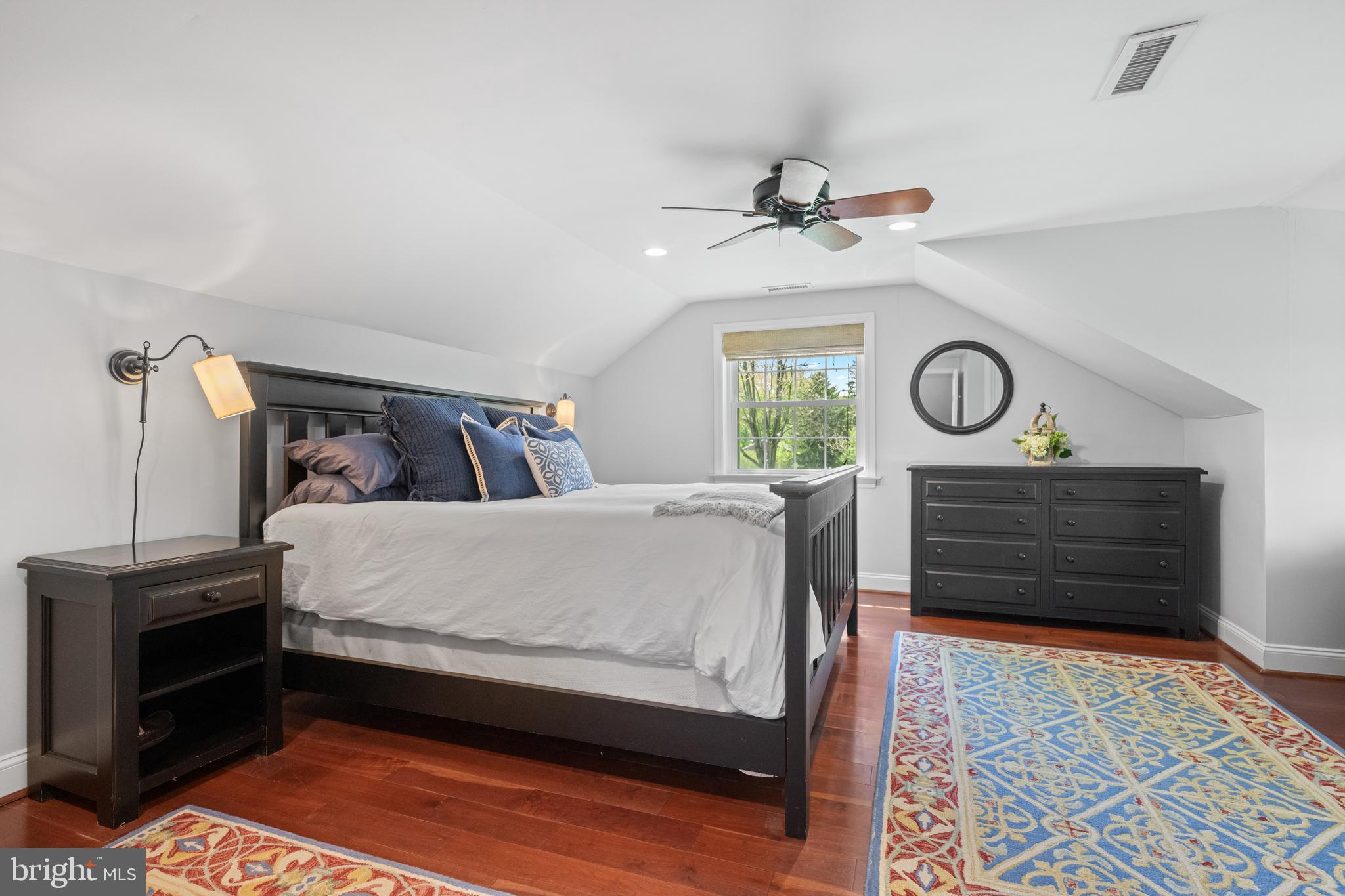 207 Anthony Wayne Drive Wayne, PA 19087 - Photo 28 of 47 a bed sitting in a bedroom next to a window and a chandelier