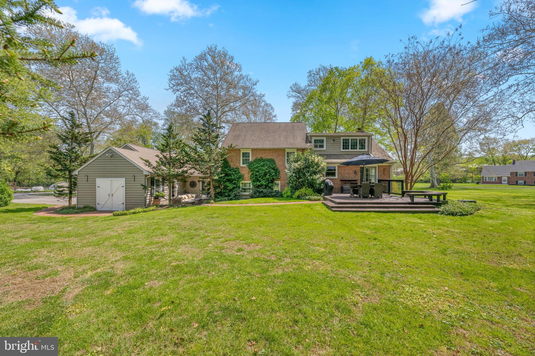 207 Anthony Wayne Drive Wayne, PA 19087 - Photo 3 of 47 a front view of a house with a garden and trees