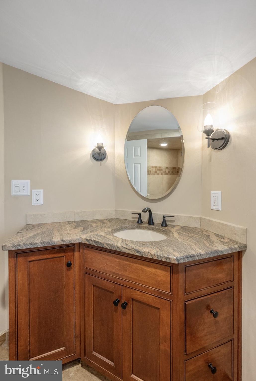 207 Anthony Wayne Drive Wayne, PA 19087 - Photo 32 of 47 a bathroom with a granite countertop sink a mirror and vanity