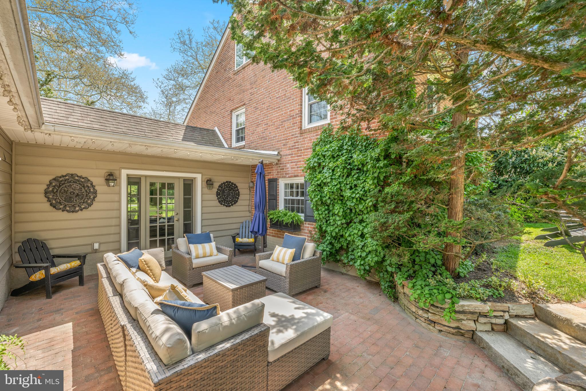 207 Anthony Wayne Drive Wayne, PA 19087 - Photo 42 of 47 a view of a patio with couches table and chairs with wooden fence and plants