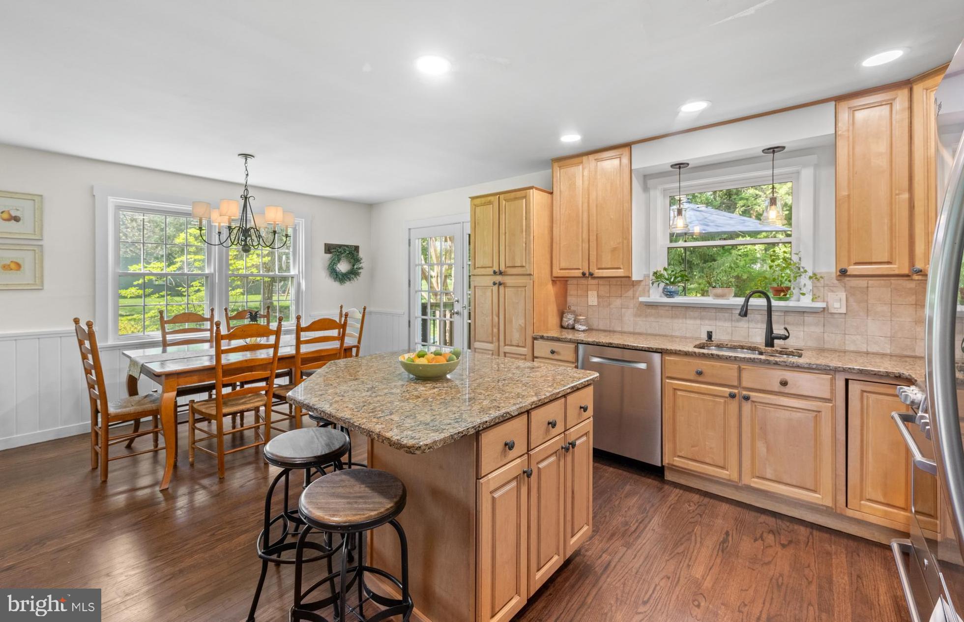 207 Anthony Wayne Drive Wayne, PA 19087 - Photo 10 of 47 a kitchen with a stove a sink a dining table and chairs