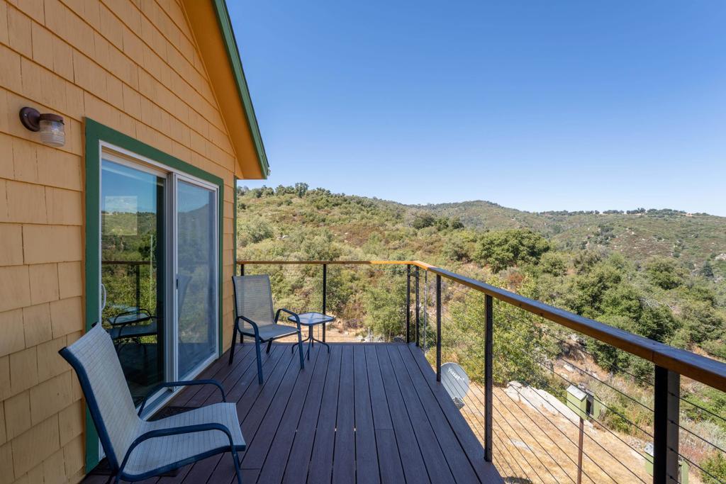 25770 East Grade Road Santa Ysabel, CA 92070 - Photo 9 of 75 a view of a balcony with furniture and wooden floor