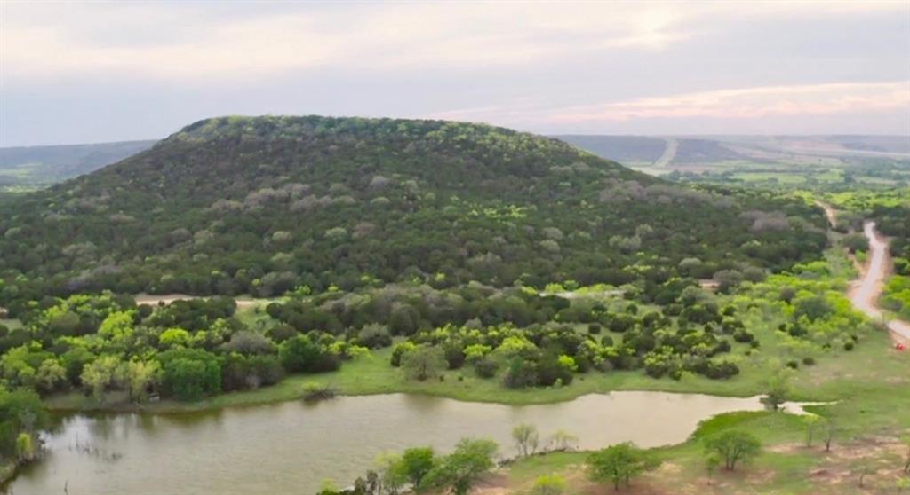 494 Co Road Strawn, TX 76475 - Photo 1 of 13 a view of a lake with a mountain in the background