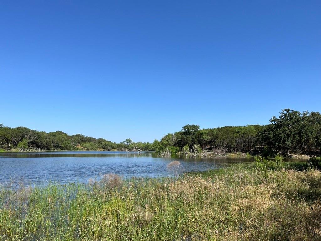 494 Co Road Strawn, TX 76475 - Photo 8 of 13 a view of a lake with houses in the back