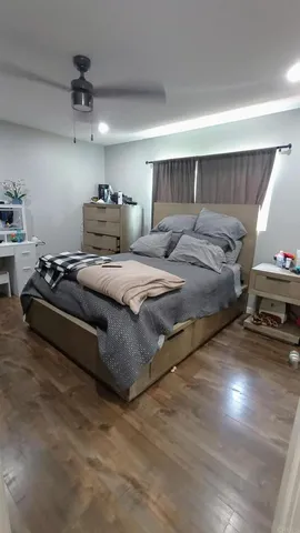 a bedroom with bed and a chandelier