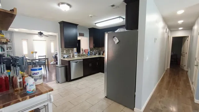 a kitchen with stainless steel appliances granite countertop a refrigerator and a sink