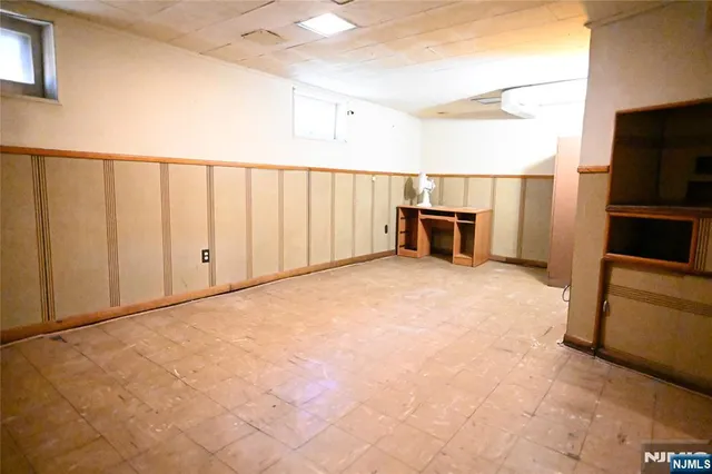 a view of a kitchen with microwave and furniture