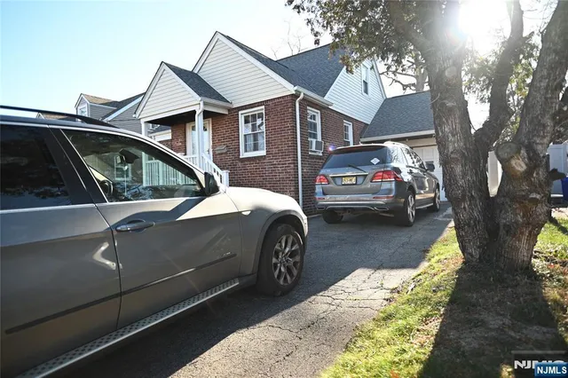 a view of a car parked in front of a house