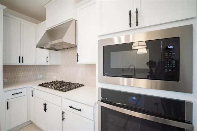 a view of kitchen with sink window and stainless steel appliances