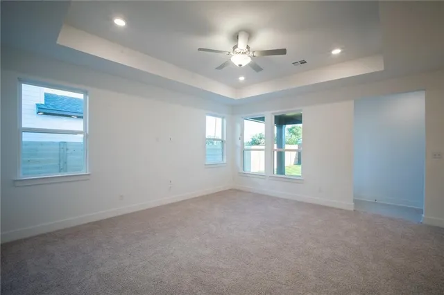 a kitchen with white cabinets and chandelier