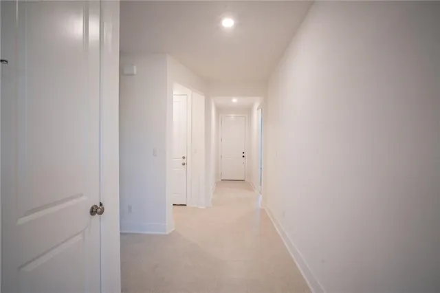 a kitchen with granite countertop white cabinets and stainless steel appliances