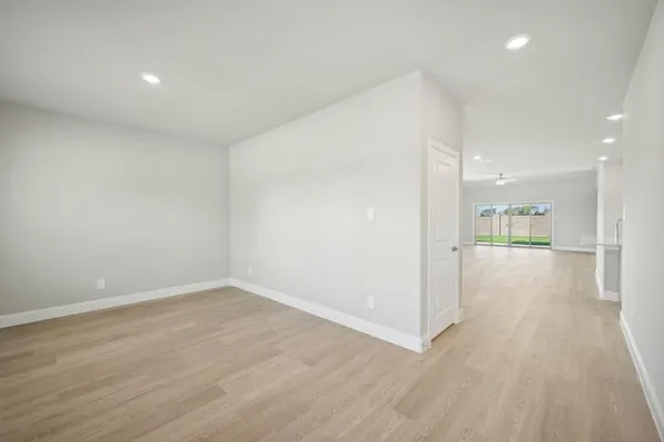 a view of a hallway with wooden floor