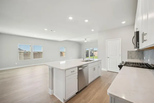 a kitchen with a sink stove and cabinets