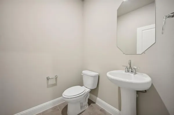 a bathroom with a sink a toilet and mirror