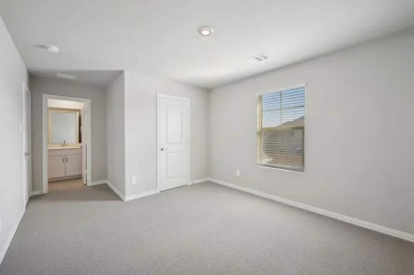 a view of an empty room and a window