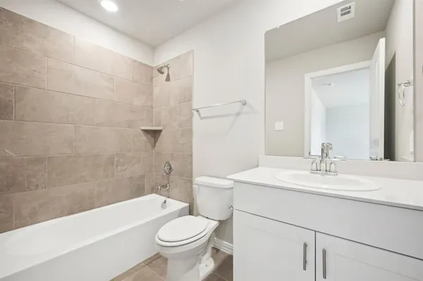 a bathroom with a sink a toilet and bathtub