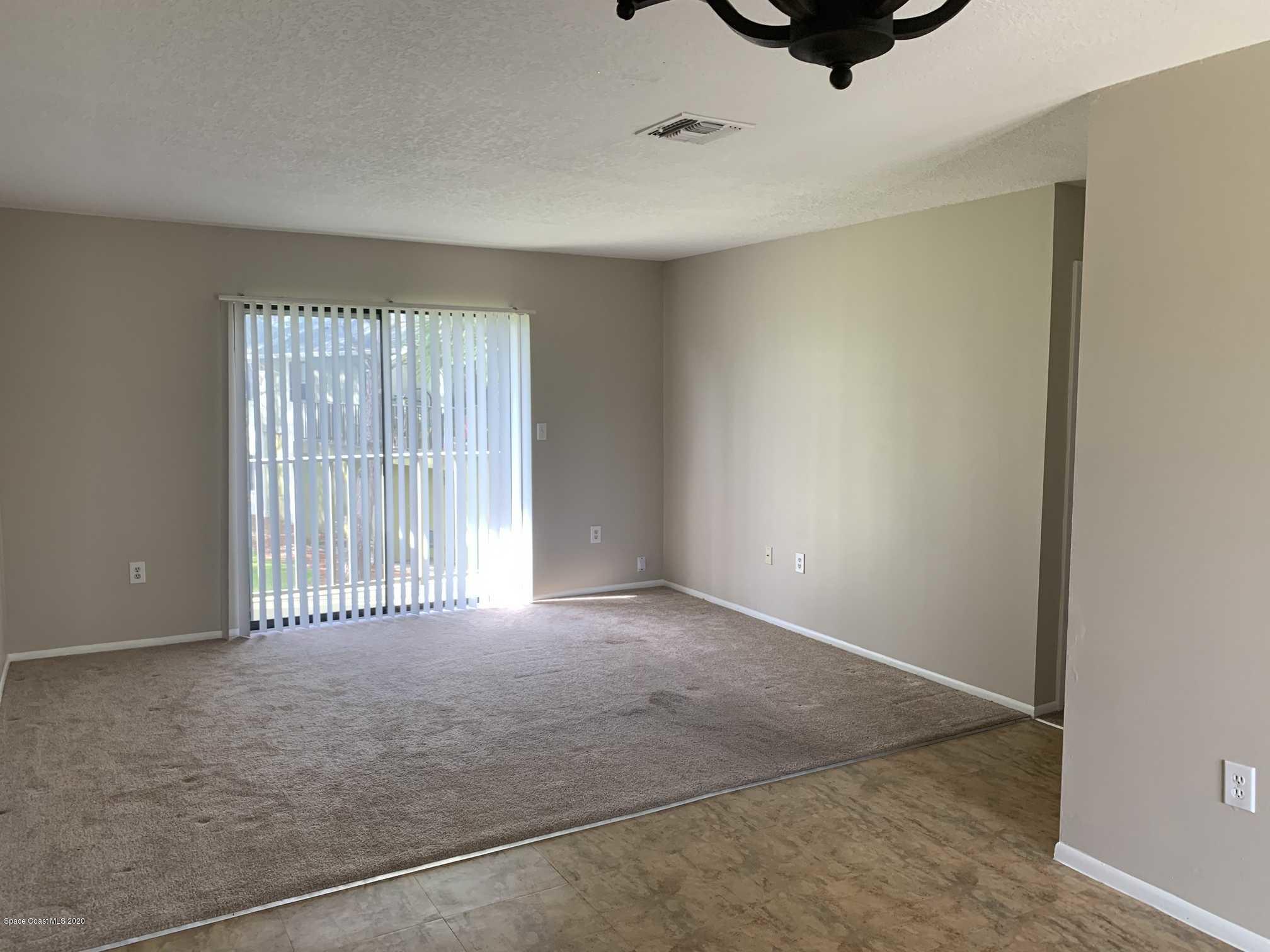 2222 Flower Tree Circle Melbourne, FL 32935 - Photo 2 of 17 an empty room with windows & cabinet