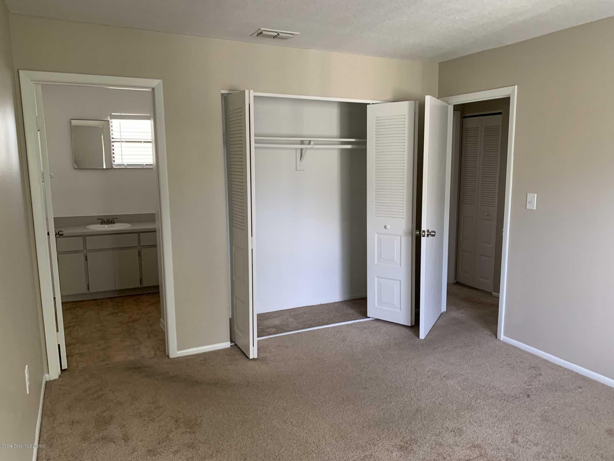 2222 Flower Tree Circle Melbourne, FL 32935 - Photo 12 of 17 an empty room with a door and closet