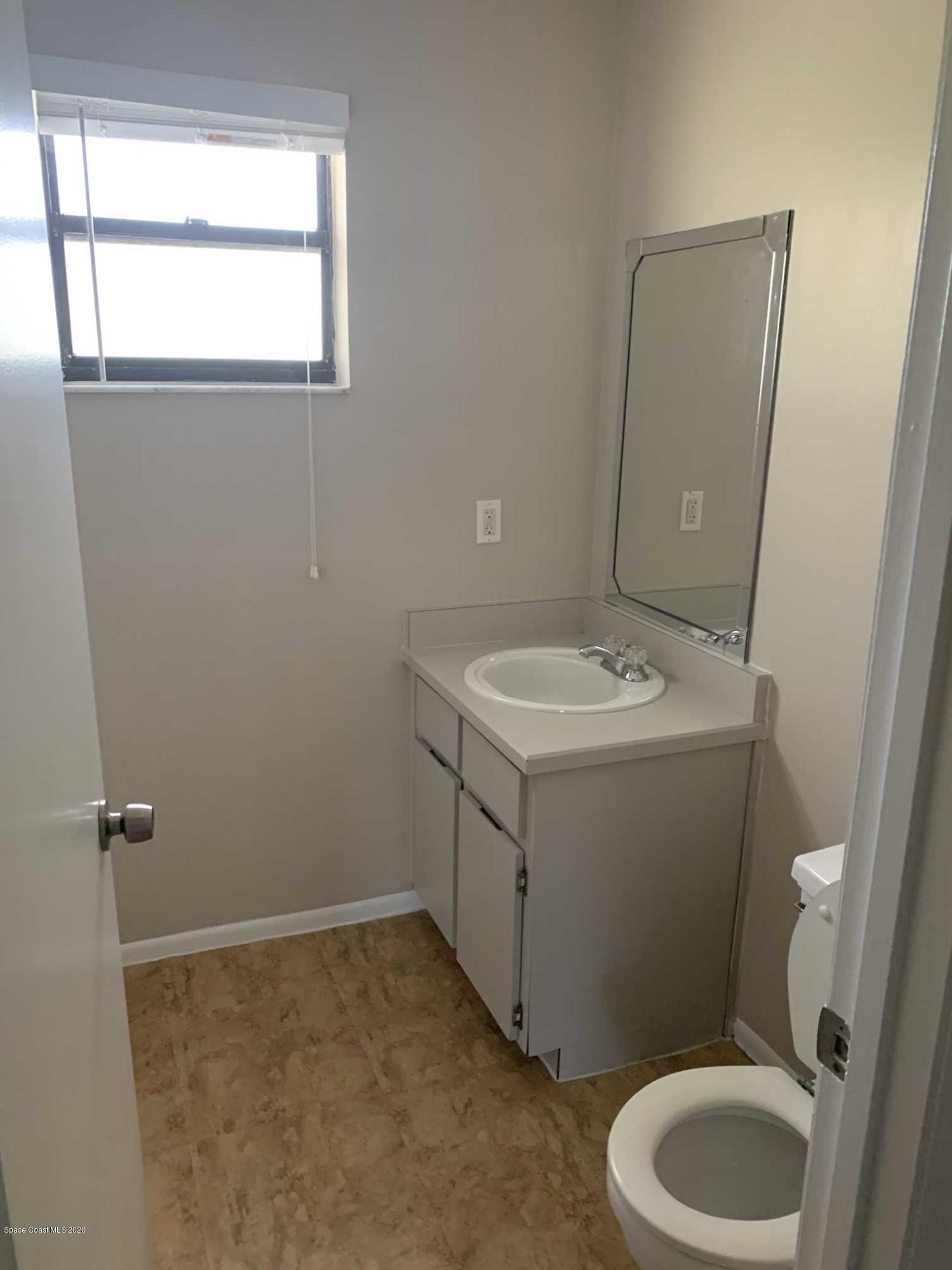 2222 Flower Tree Circle Melbourne, FL 32935 - Photo 15 of 17 a bathroom with a sink toilet and window