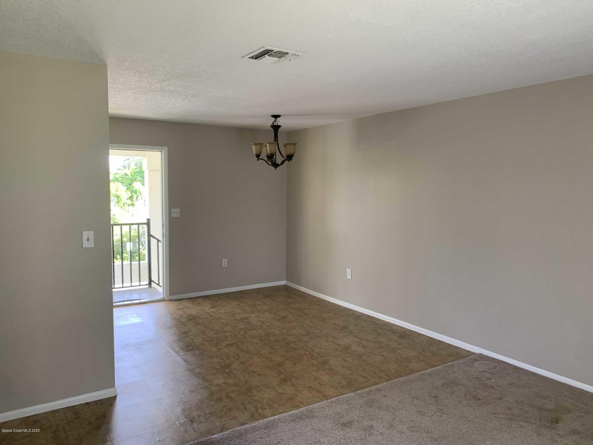 2222 Flower Tree Circle Melbourne, FL 32935 - Photo 3 of 17 wooden floor in an empty room with a window