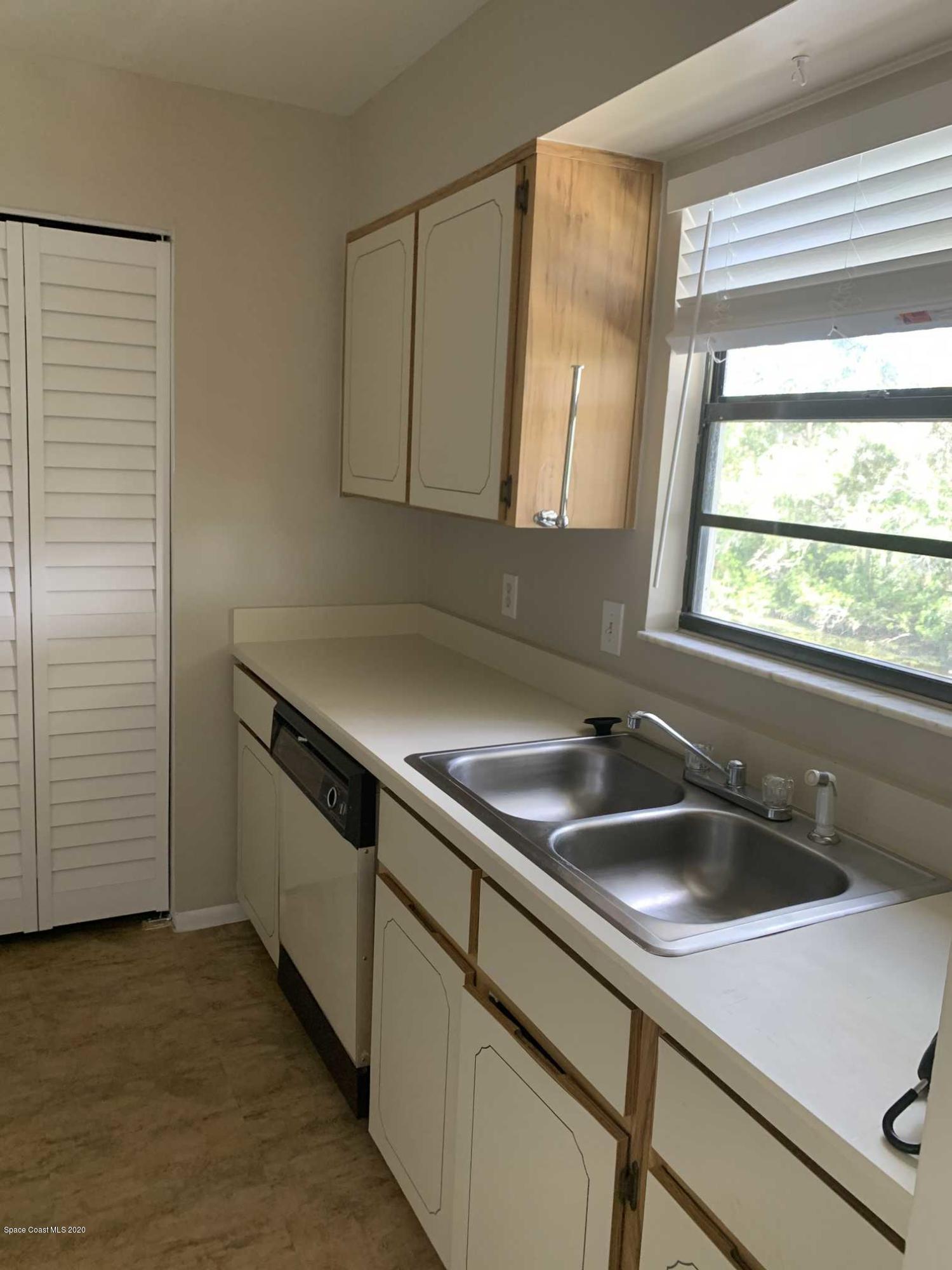 2222 Flower Tree Circle Melbourne, FL 32935 - Photo 5 of 17 a kitchen with a sink and cabinets