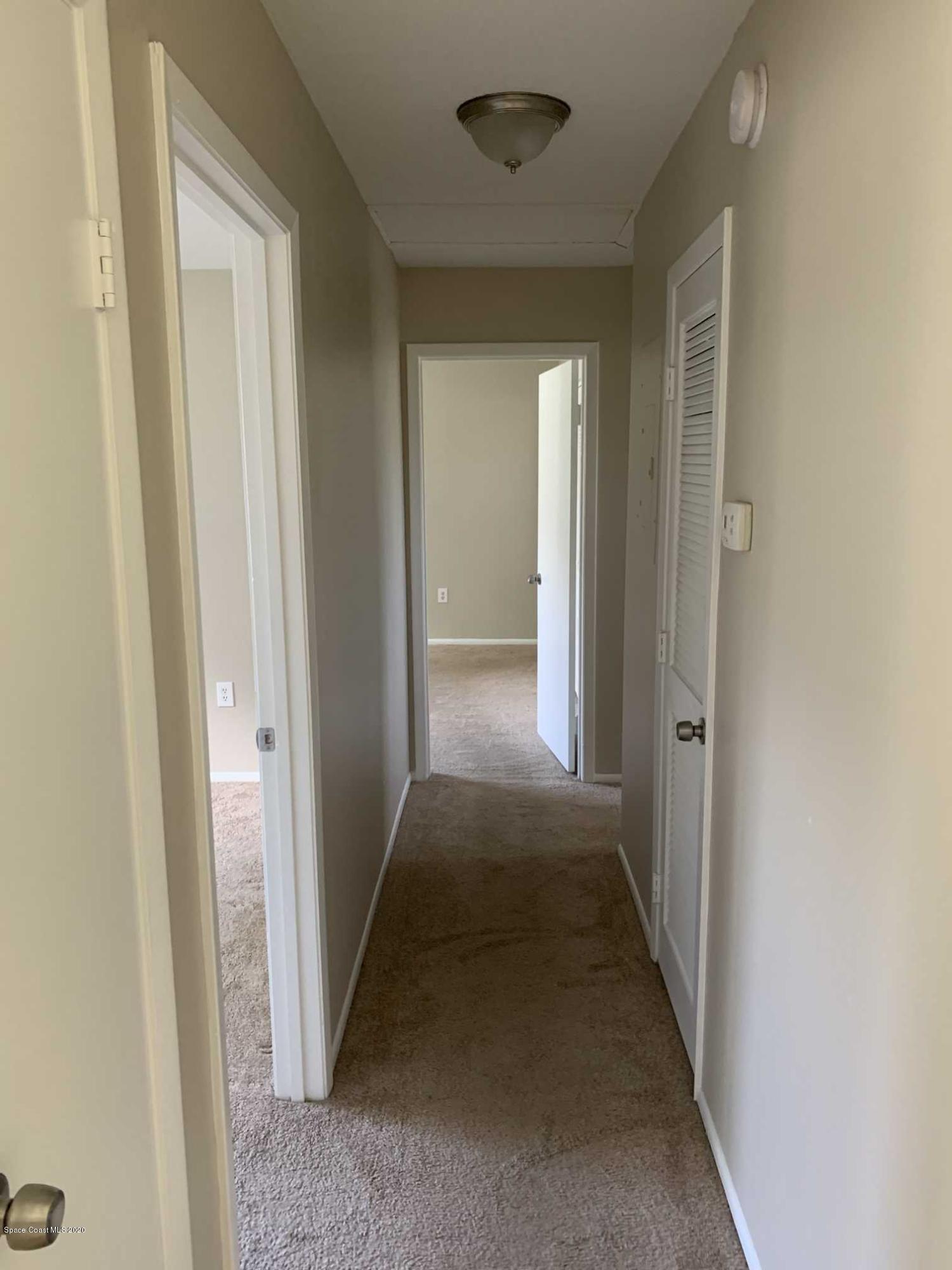 2222 Flower Tree Circle Melbourne, FL 32935 - Photo 8 of 17 a view of a hallway with a wooden door