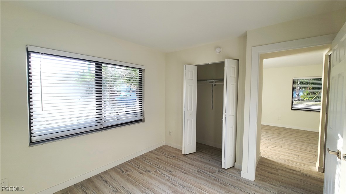 2610 Providence Street, Unit 1 Fort Myers, FL 33916 - Photo 11 of 16 a view of an empty room with wooden floor and a window