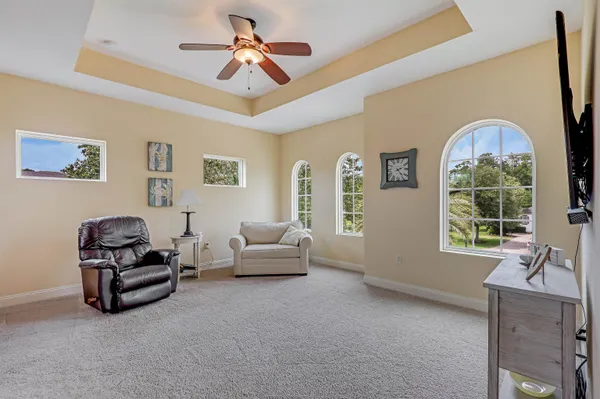 a dining room with wooden floor a chandelier a wooden table and chairs