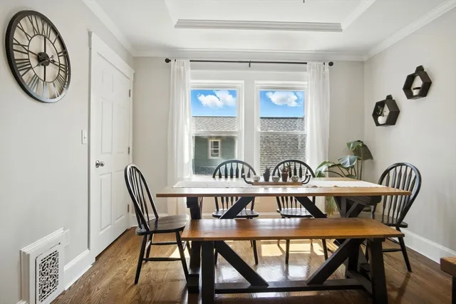 a view of a dining room with furniture window and wooden floor