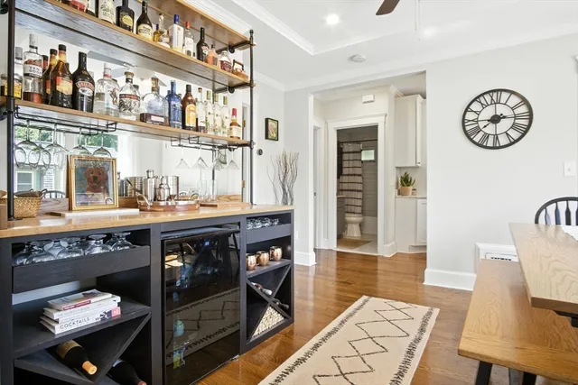 a open kitchen with stainless steel appliances granite countertop a stove and a table