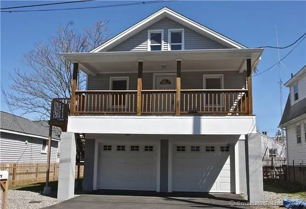 a back view of a house with wooden deck