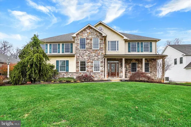 a front view of a house with a yard and porch