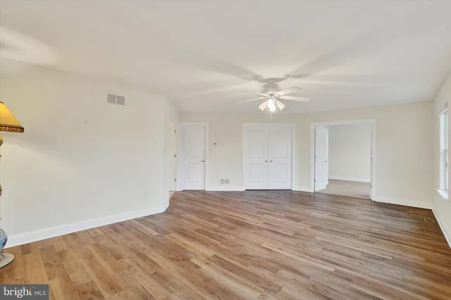 a view of an empty room with windows