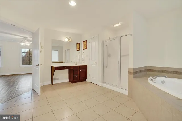 a view of an empty room with a ceiling fan and a window