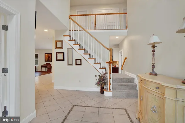 a large kitchen with kitchen island granite countertop a stove top oven a sink a counter space and cabinets