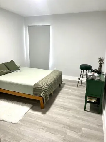 a bedroom with a bed and a table