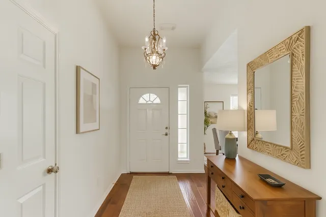 a view of a livingroom with furniture and hardwood floor