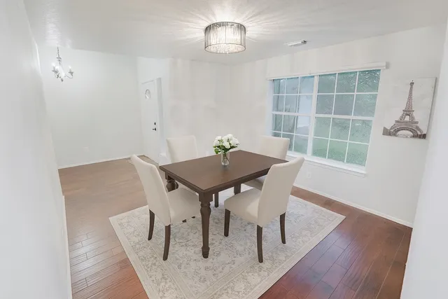 a view of a dining room with furniture and wooden floor