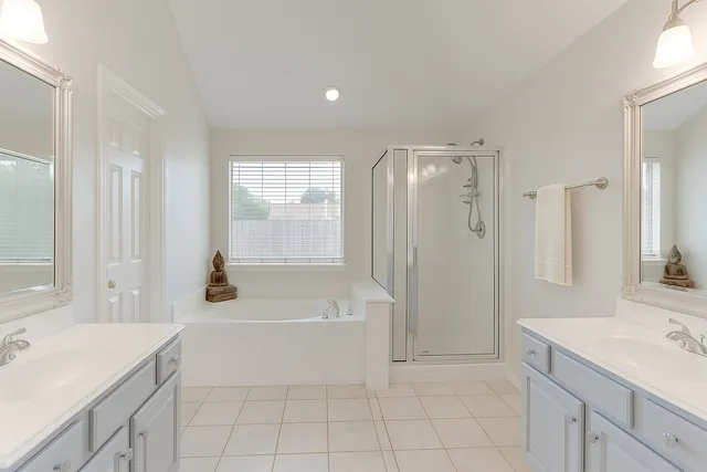 a bedroom with a bed and a potted plant