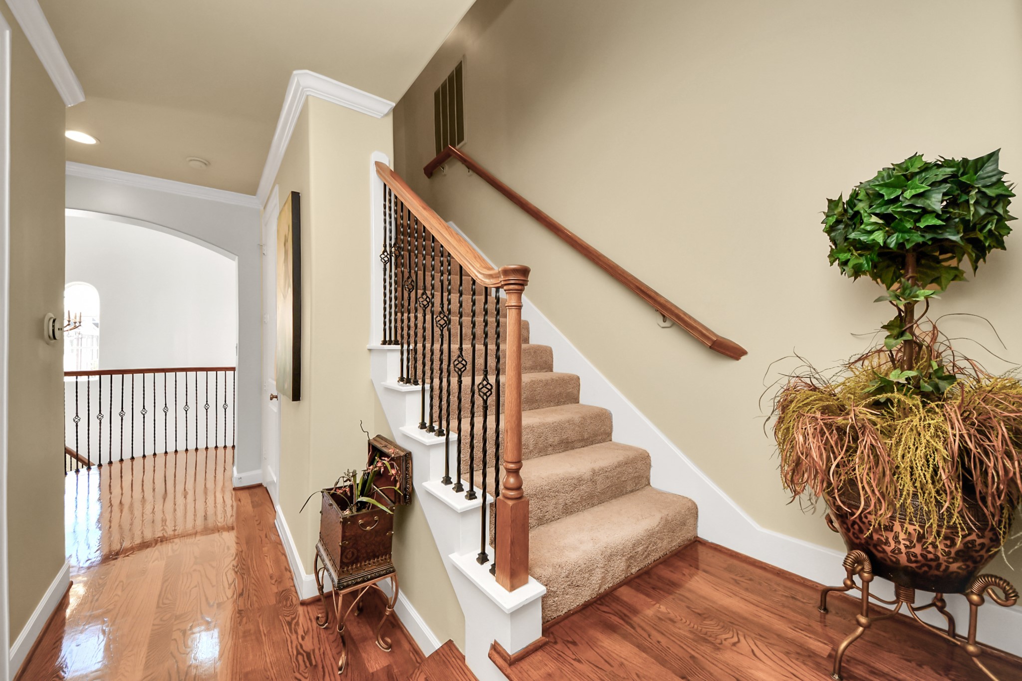 6302 Hermann Lake Drive Houston, TX 77021 - Photo 36 of 50 Continuing upstairs, a beautifully crafted staircase with rich wood floors, decorative iron balusters, and a warm wood handrail leads you to the third level.