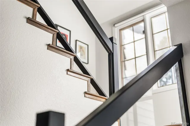 a view of staircase with railing and a window