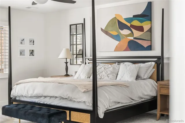 a bedroom with a bed and wall painting