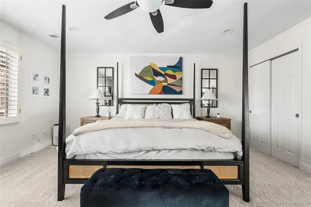 a bedroom with a bed and ceiling fan