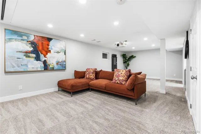 a living room with furniture and wall painting