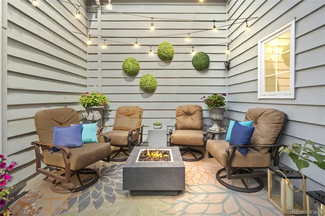 a view of patio with chairs and a potted plant