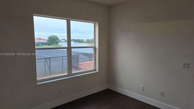 a bathroom with a granite countertop sink a toilet and mirror