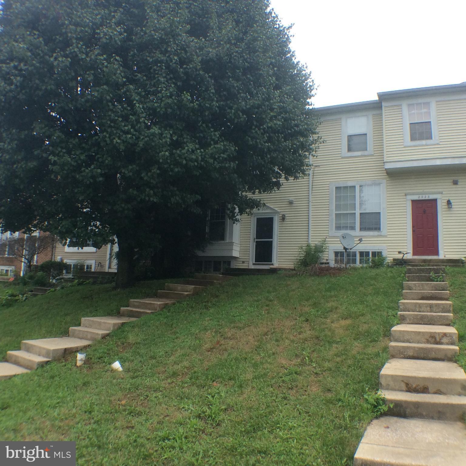 2021 Putnam Road Baltimore, MD 21227 - Photo 1 of 18 a front view of a house with a garden